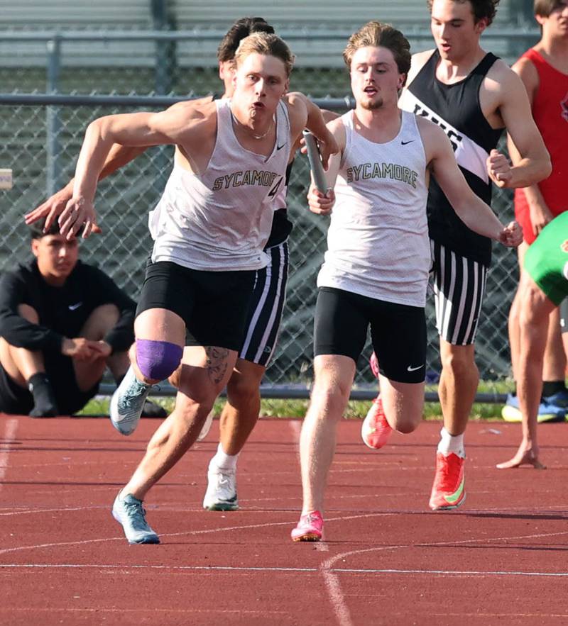 Sycamore’s Aidan Wyzard (left) takes the handoff from Preston Picolotti in the 4x100 relay Tuesday, May 13, 2025, during the Interstate 8 Conference boys track championships at Rochelle High School. Sycamore would go on to win the relay.