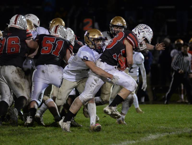 Forreston's Owen Mulder (33) hangs on to the ball at the end of a run during 1A football playoff action against Ottawa Marquette on Friday, Oct.27, 2023 at Forreston High School.