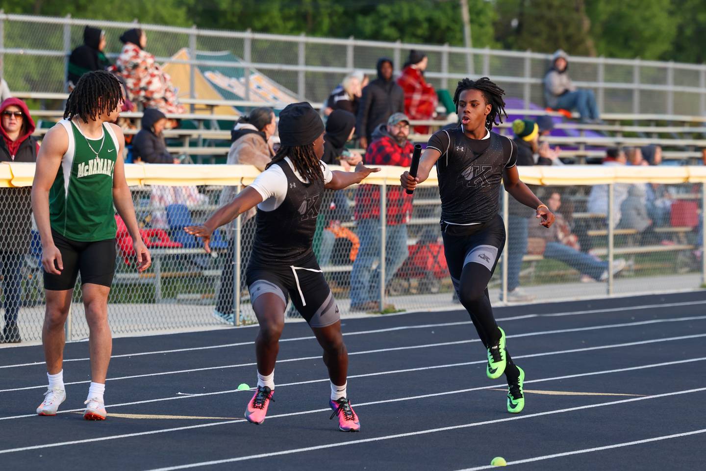 Kankakee's Dominic White hands the baton to Kymani Billings during the 4x200 relay race at the Herscher Track Invite on Friday, May 1, 2026.