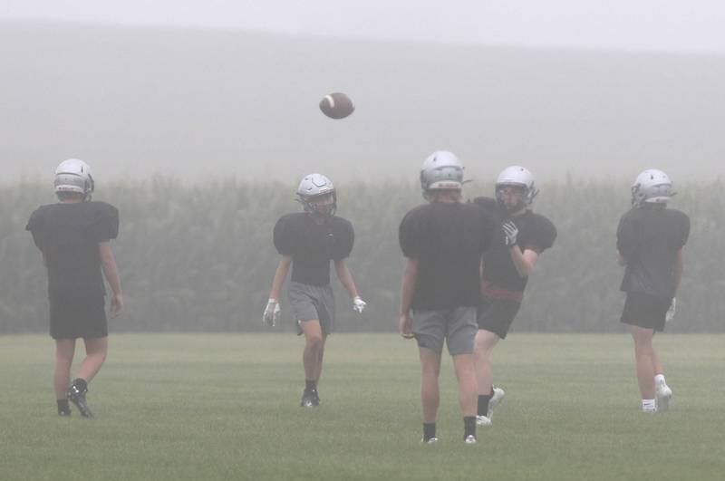 Kaneland lower grade level players practice in the fog Wednesday, Aug. 9, 2023, at the school in Maple Park.