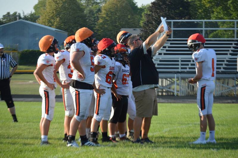 Dusty Behringer coaching the Sandwich High School football team.