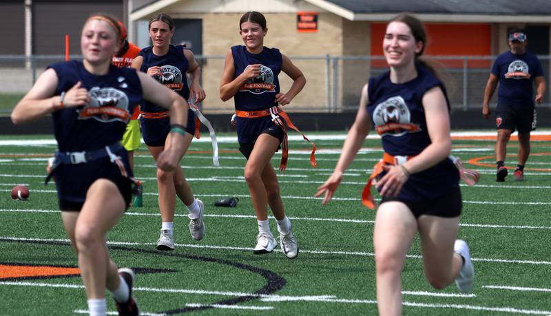 Athletes hustle between drills as the Chicago Bears and McHenry Community High School hosted a flag football clinic at McCracken Field Wednesday.