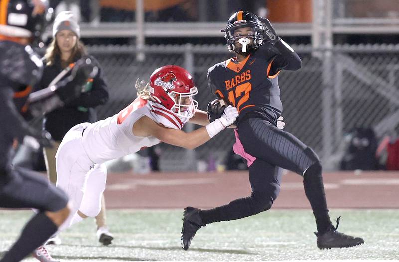 DeKalb's Ethan McCarter tries to pull away from Naperville Central's Jack Lecrone after a long reception during their game Friday Oct. 7, 2022, at DeKalb High School.