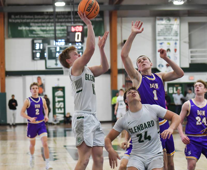 Glenbard West’s Chase Cavan puts up a shot in a crowd during a game against Downers Grove North on January 23, 2026 at Glenbard West High School in Glen Ellyn.