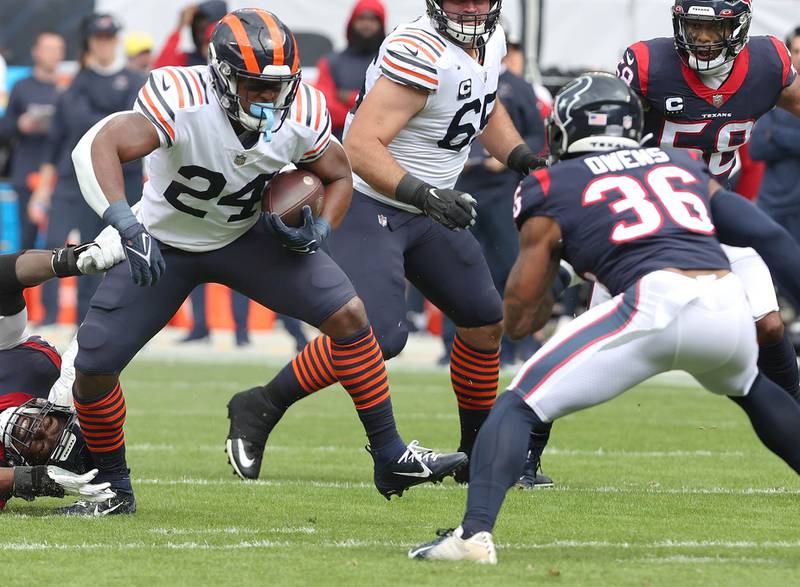 Chicago Bears running back Khalil Herbert looks to get by Houston Texans safety Jonathan Owens during their game Sunday, Sept. 25, 2022, at Soldier Field in Chicago.