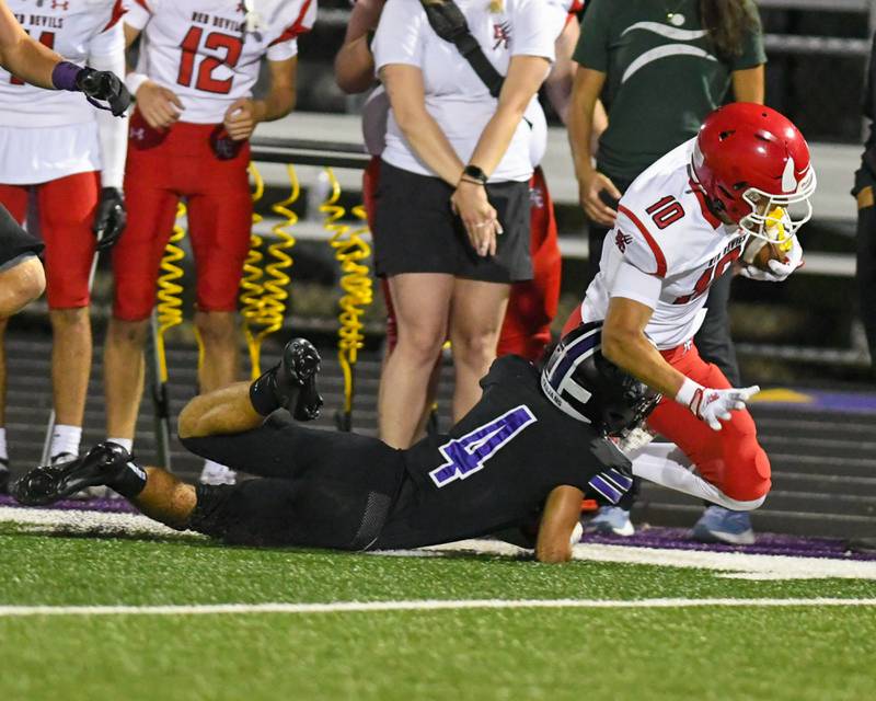 Hinsdale Central's Spencer Martin (10) runs the ball while being pushed out of bounds by Downers Grove North's Caden Chiarelli (4) during the game on Friday Sept. 12, 2025, held at Downers Grove North High School.