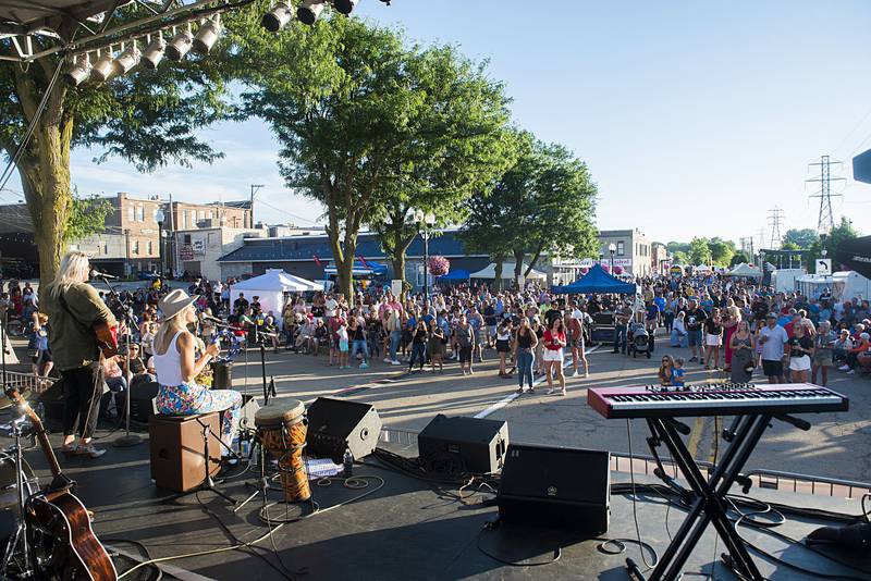 Friends, family and supporters of Gina Venier gather around the stage to hear the up and coming Nashville star Friday, July 1, 2022 at Dixon’s Petunia Fest.
