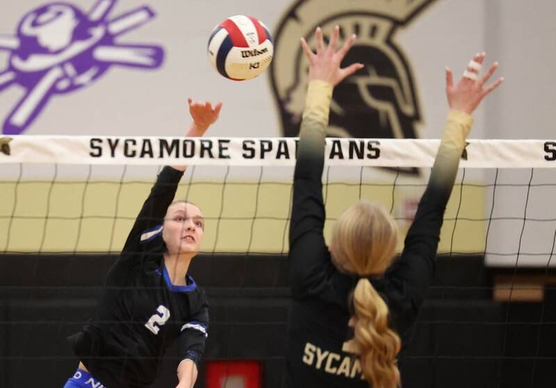 Burlington Central's Haidyn Schatz spikes the ball as Sycamore's Madilyn Patton tries to block Tuesday, Oct. 29, 2024, during their Class 3A regional match at Sycamore High School.