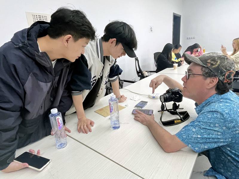 For three weeks in October, Chester Alamo-Costello (right) professor of art and design at the University of St. Francis in Joliet, and Joshua Wilson, an adjunct art professor at USF, taught design classes to more than 100 students a day at in Zigong City, Sichuan Province, China.
