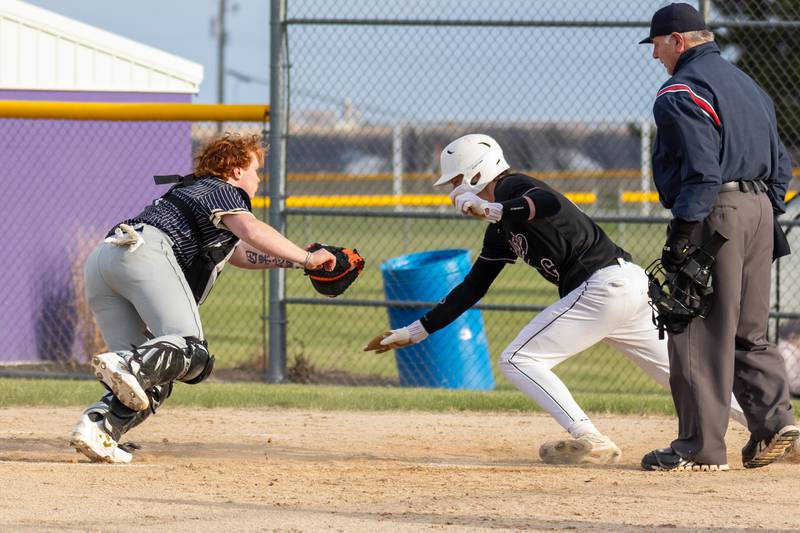 Payton Twait of Serena attempts to touch home base as Tommy Butler of Hiawatha attempts to tag him out on Monday, April 7, 2025 at Serena High School in Serena.
