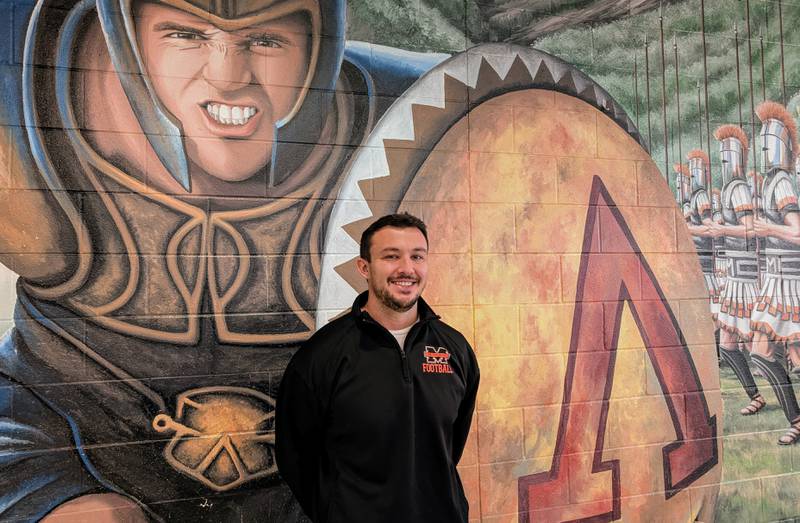 New McHenry football coach Colt Nero poses for a picture in the McHenry Upper Campus cafeteria Thursday, Jan. 23, 2025, in McHenry. Nero, a Crystal Lake South graduate, served two stints as an assistant coach at McHenry.