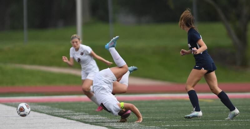 Lincoln-Way Central’s Grace Grundhofer flips over after a collision with Evanston’s Lucinda Lindland, right, in the Class 3A IHSA state girls soccer third-place game in Naperville on Saturday, June 4, 2022.