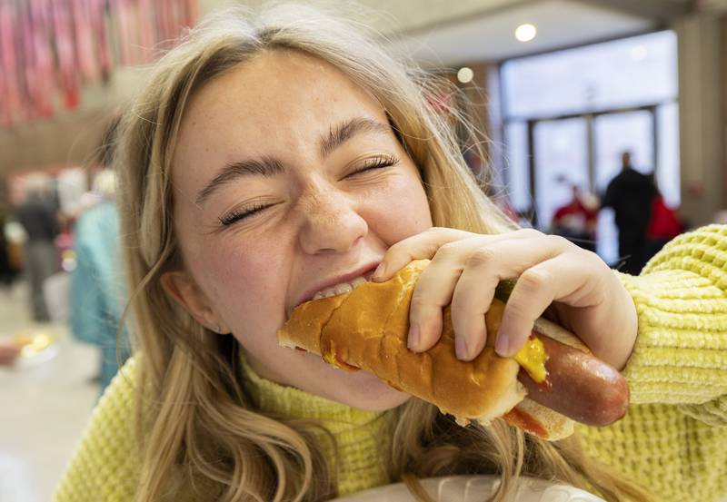 Chloe Coil of Dixon digs into a dog at SVCC’s SaukFest on Wednesday, Feb. 1, 2023. Dog and burgers were a couple of the treats on the menu for the welcome back to school celebration.