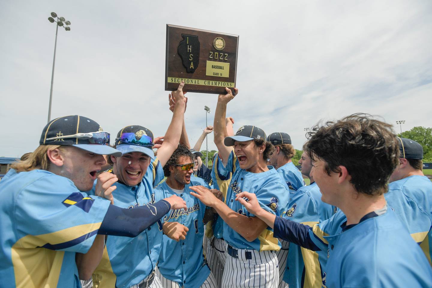 Marquette celebrates its 4-1 victory over Putnam County for the Class 1A Harvest Christian Sectional title at Judson College in Elgin on Saturday, May 28, 2022.