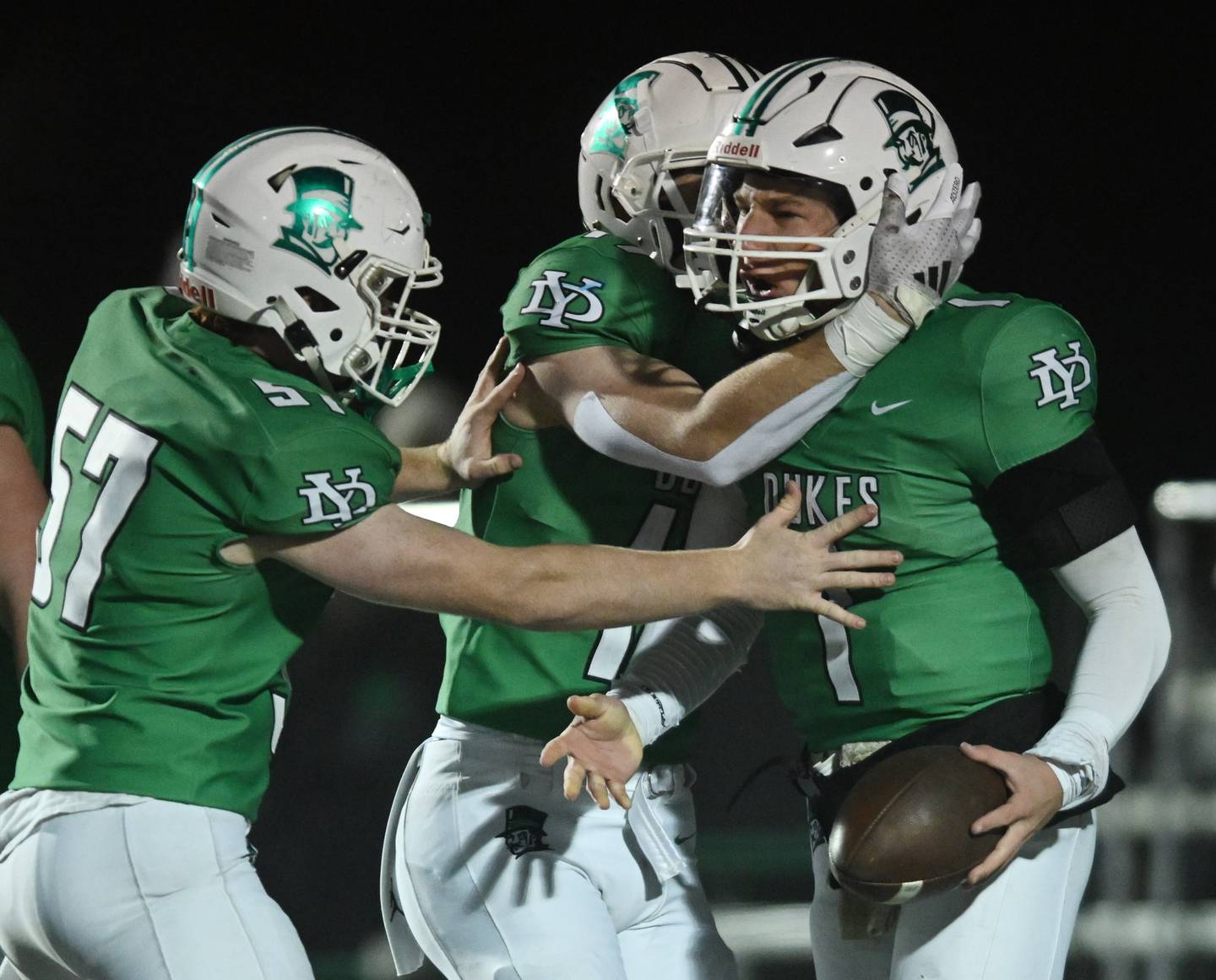York’s Bruno Massel, right, celebrates a first-quarter touchdown with teammates Jack Bodach, left, and Fintan Helm during a Class 8A football quarterfinal on Friday, Nov. 15, 2024 in Elmhurst.