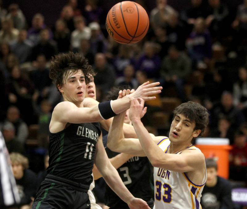 Glenbard West’s Logan Brown (left) and Downers Grove North’s Finn Kramper (right) go after a rebound during a game at Downers Grove North on Friday, Jan. 13, 2023.