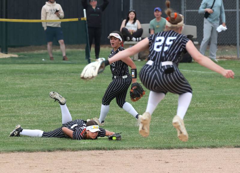 Crystal Lake Central's Brooklyn Johnson makes a diving catch for the third out to prevent Sycamore, who had runners on base, from scoring as her teammates celebrate Tuesday, June 3, 2025 during their Class 3A sectional semifinal game at Sycamore High School.