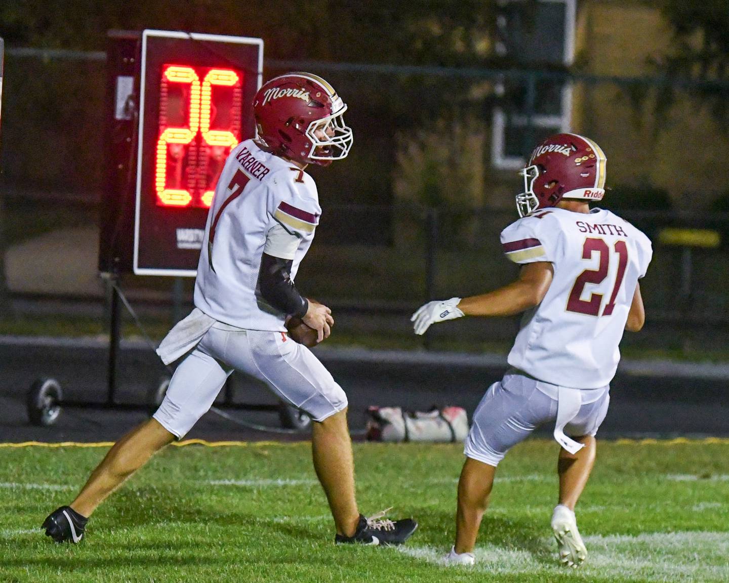Morris's Brady Varner (7) gets congratulated by teammate Anthony Smith (21) after Brady scores a touchdown during the game on Friday Sept. 26, 2025, while traveling to take on Kaneland High School.