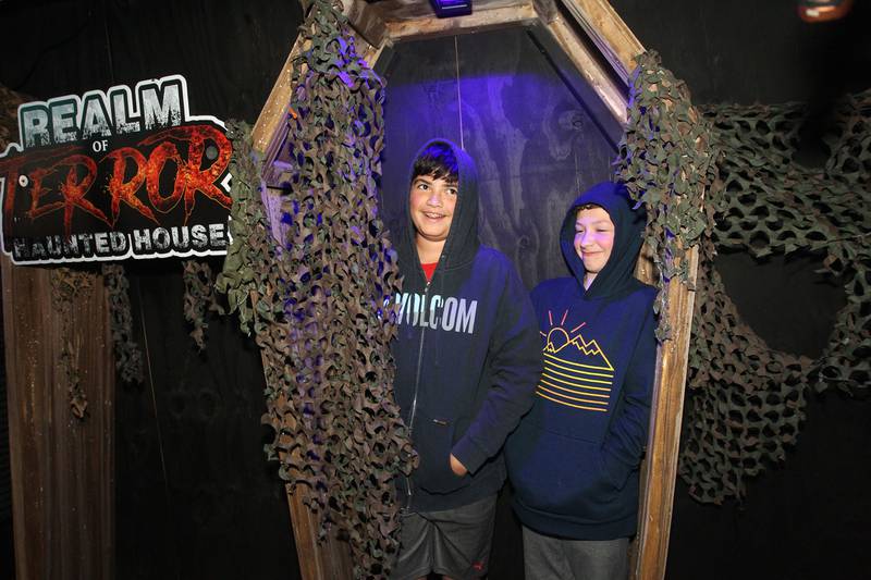 Beck Shedbalkar and Joe Spaw, both 12, of Johnsburg have fun standing in a coffin at the Realm of Terror Haunted House in Round Lake Beach