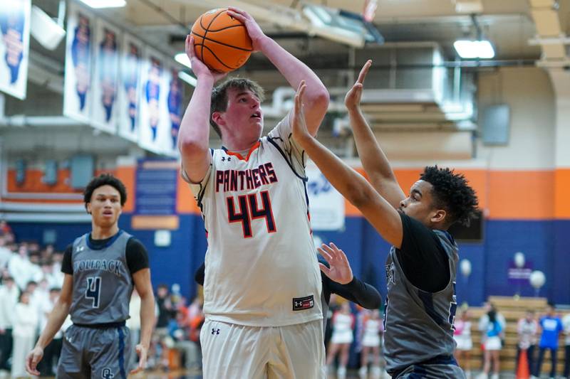 Oswego’s Hunter O’Neill (44) shoots the ball in the post over Oswego East's Torrin Ross (23) during a basketball game at Oswego High School on Tuesday, February 18, 2025.