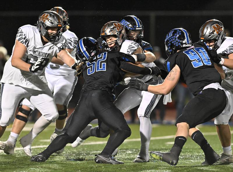 Minooka's quarterback Nathan Maul gets sacked by Lincoln-Way East's defensive end Josiah Manumaleuna (52) during the class 8A second round playoff game on Friday, Nov. 03, 2023, at Franfort. (Dean Reid for Shaw Local News Network)