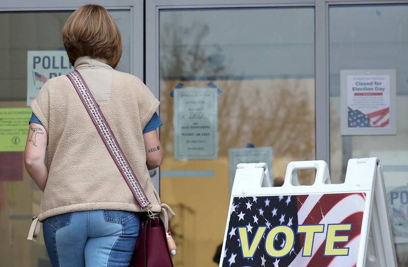 A voter walks into the DeKalb Public Library Tuesday, Nov. 5, 2024, Election Day, to cast their ballot.