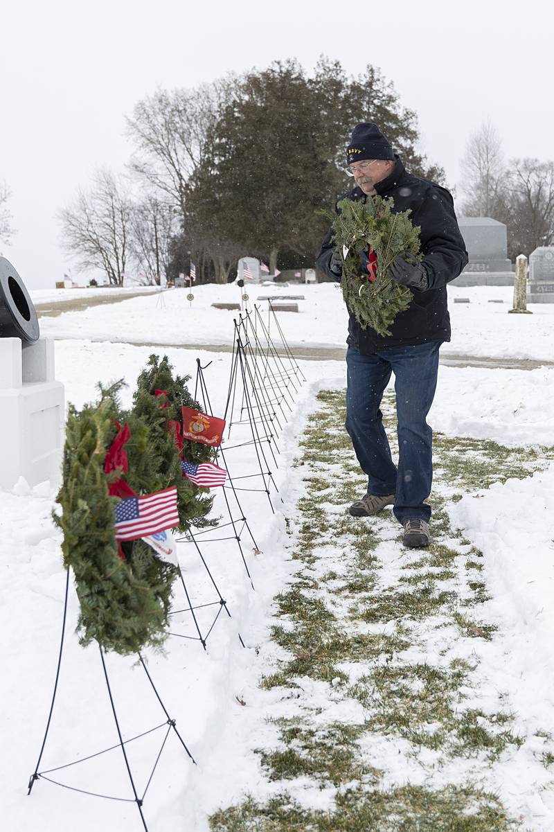 Mike Barney places a wreath Saturday, Dec. 13, 2025, in recognition of the U.S. Navy.