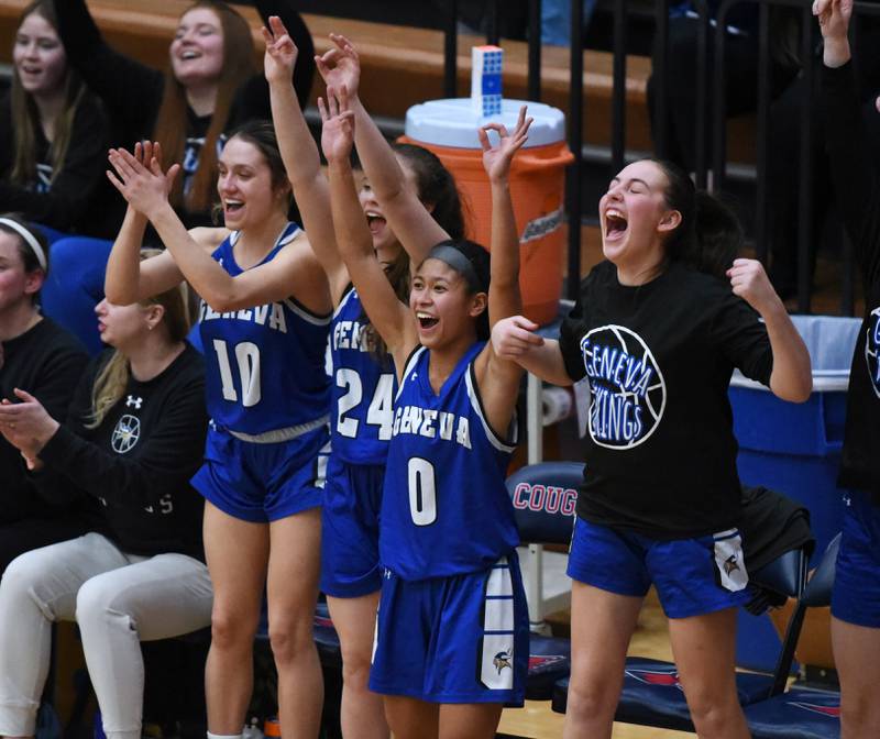 Geneva's Rilee Hasegawa (0) celebrates a basket with teammates in the closing minutes of Friday’s IHSA Class 4A girls basketball regional championship game against Conant in Hoffman Estates.