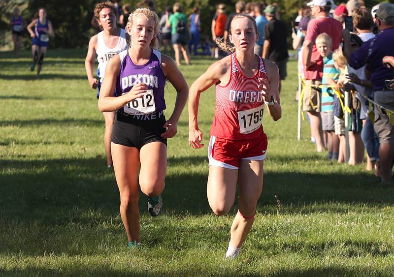 Dixon's Emma Smith and Oregon's Ella Dannhorn sprint towards the finish line Tuesday, Aug. 30, 2022, during the Sycamore Cross Country Invitational at Kishwaukee College in Malta.