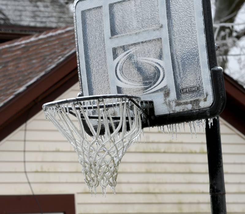 Ice covers a basketball hoop and backboard on Thursday afternoon in Forreston. Freezing rain fell across portions of Ogle County causing electrical outages across the area.