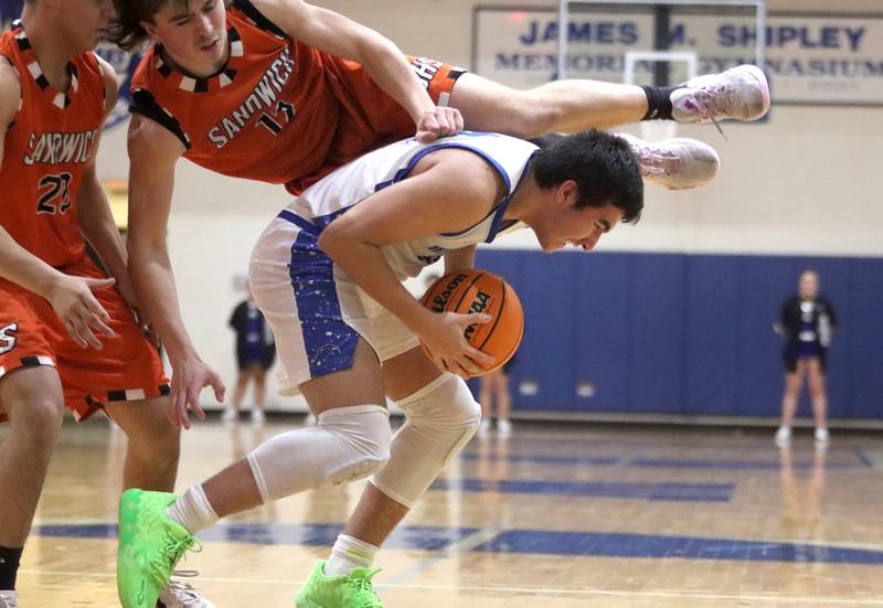 Woodstock’s Ayden Cummings, bottom, keeps the ball from Sandwich’s Braden Behringer in varsity boys basketball on Tuesday, Feb. 11, 2025, at  Woodstock High School in Woodstock.