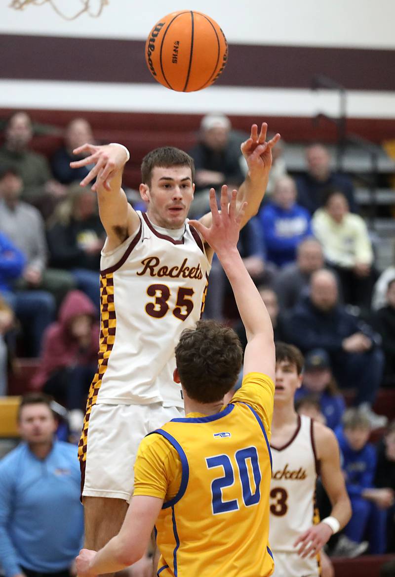 Richmond-Burton's Jace Nelson passes the ball over Johnsburg's Josh Kaunas during a Kishwaukee River Conference boys basketball game on Tuesday, Jan. 27, 2026, at Richmond-Burton High School.