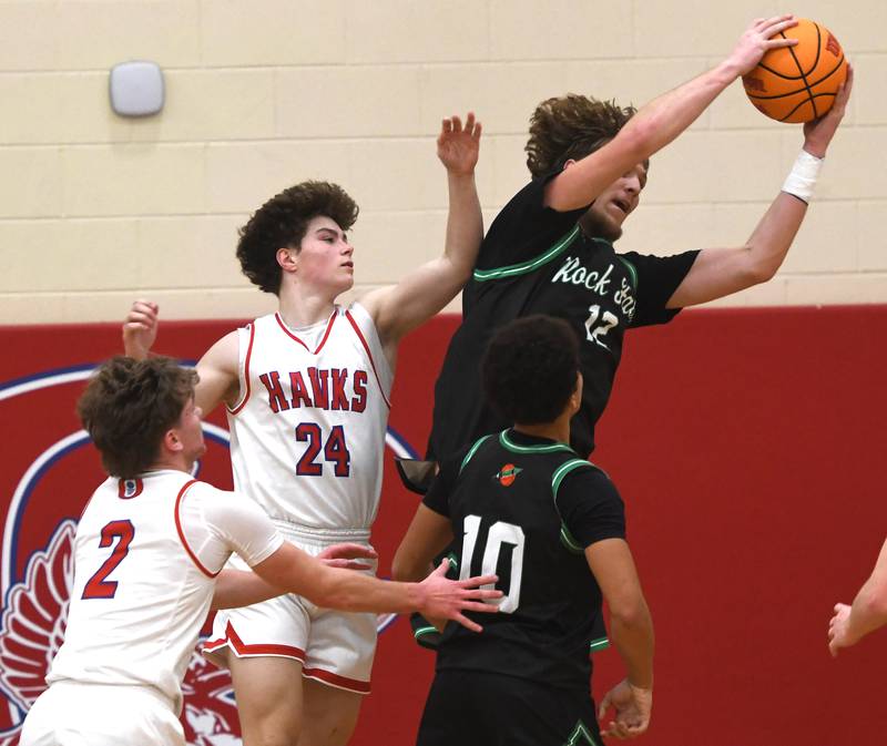 Rock Falls' Cole Munix (12) snags a rebound against Oregon's Cooper Johnson (2) and Ethan Peeling (24) on Friday, Jan. 9, 2026 at the Blackhawk Center in Oregon.