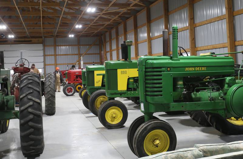 Tractors fill a shed during the Pat and Sharon Broeren auction on Saturday, Dec. 13, 2025 at Dahl Real Estate Auctions and Appraisals in Walnut.