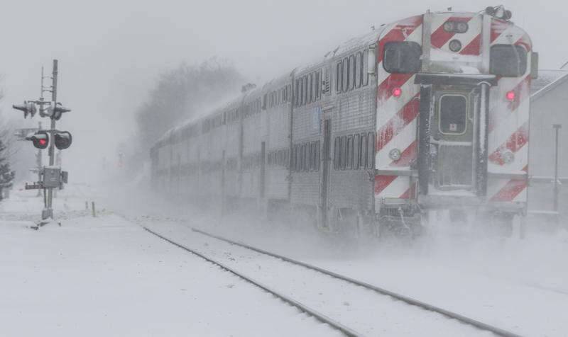 Heavy snow is disrupting Metra commutes and flights out of O'Hare and Midway airports on Friday.