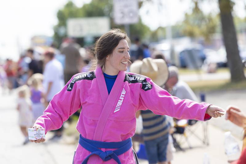 Stacey Penaflor of Sauk Valley Jiu Jitsu hands out coupons Saturday, Sept. 14, 2024, during the Fiesta Days parade.