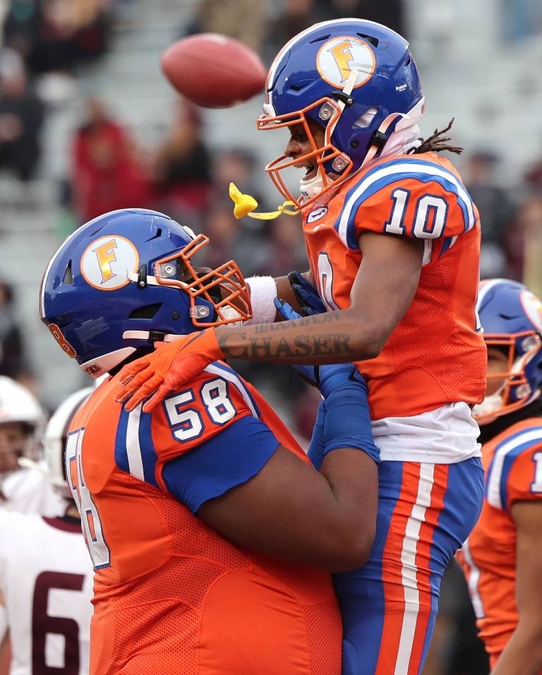 East St. Louis' Jesse Watson gets a lift from Miles McVay after Watson scored a touchdown during their IHSA Class 6A state championship game against Prairie Ridge Saturday, Nov. 26, 2022, in Memorial Stadium at the University of Illinois in Champaign.