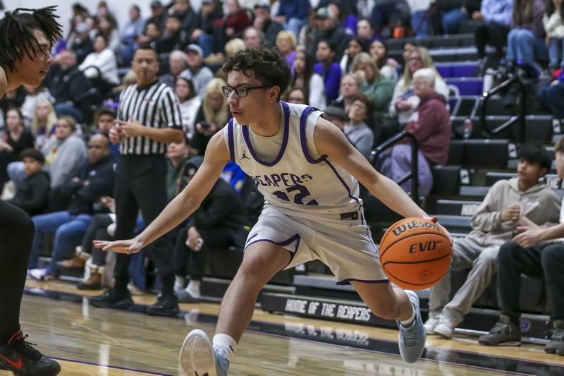 Plano's Jayden Zepeda (22) makes a baseline move during their basketball game between Sandwich at Plano Tuesday, Dec 9, 2025 in Plano.