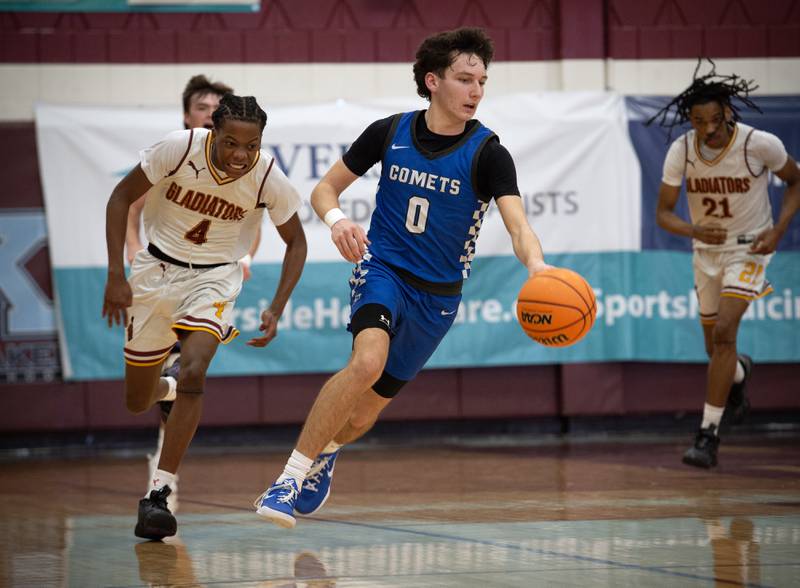 Clifton Central's Derek Meier, center, leads on a break over Christ the King's Jermaine Thomas, left, during a game in the Kankakee Holiday Tournament at Kankakee High School on Saturday, December 27, 2025.