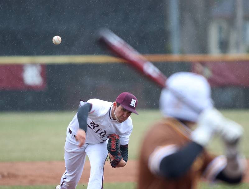 Rain continues to fall as Prairie Ridge’s Danny Savas delivers against Jacobs in varsity baseball on Wednesday, April 9, 2025, at Prairie Ridge High School in Crystal Lake. The game was suspended due to rain.