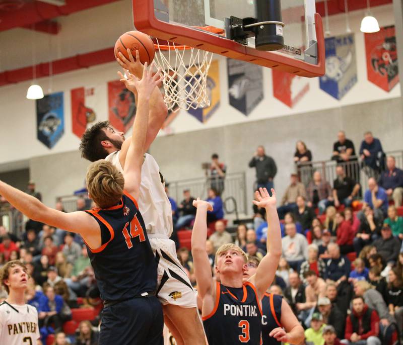 Putnam County's Jackson McDonald (center) cuts between Pontiac's Henry Brummel (left) and teammate Aithen Sullivan (right) during the Colmone Classic tournament on Friday, Dec. 9, 2022 at Hall High School in Spring Valley.