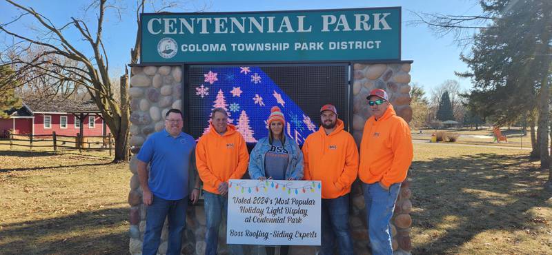 Boss Roofing was voted as 2024's Most Popular Holiday Light Display at Rock Falls' Centennial Park. Tom Henry, director of Coloma Township Park District, is pictured with employees of Boss Roofing..The voting was done by the community on Facebook.