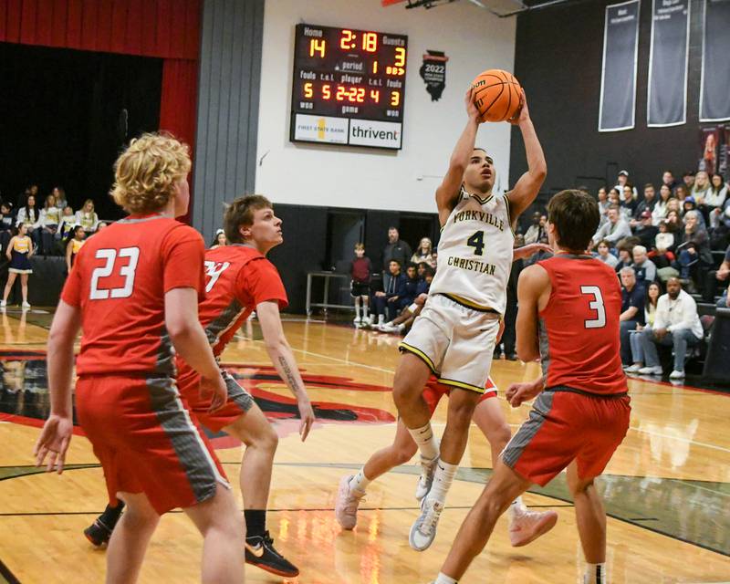 Yorkville Christian's Tray Alford (4) goes up for a shot during the game while being defended by Aurora Christan players during the game on Friday Feb. 28, 2025, held at Indian Creek High School.