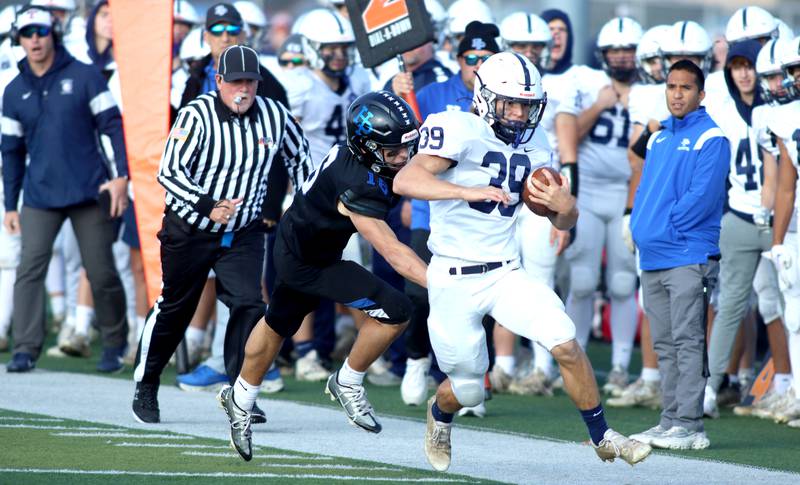 Cary-Grove’s Holden Boone runs the ball against Highland Park in second-round IHSA Class 6A playoff action at Wolters Field in Highland Park Saturday.