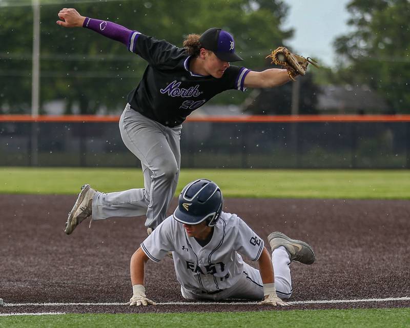 Downers Grove North's Brooks Barofsky (20) grabs a wild throw at first base during Class 4A Romeoville Sectional semifinal between Oswego East at Downers Grove North.  May 31, 2023.