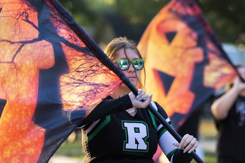 A member of the Rock Falls High School color guard marches through the homecoming parade Thursday, October 10, 2024.