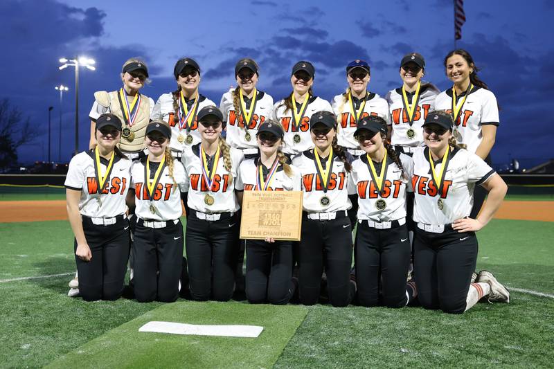 Lincoln-Way West players pose with the championship plaque after the Warriors 11-1 win over Lockport in the WJOL Softball Tournament championship game on Thursday, April 2, 2026 in Joliet.