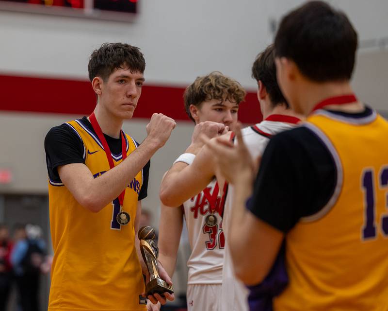 Cole Tillman (1) of Mendota fist bumps teammates after receiving the tournament MVP trophy following Mendota's win in the championship game of the Colmone Classic on Saturday, December 20, 2025 at Hall High School in Spring Valley.