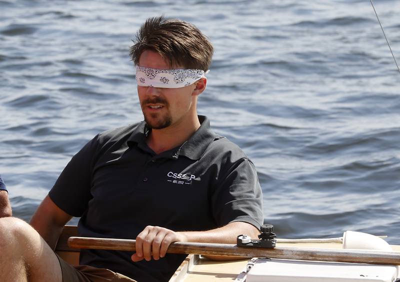 Tristan Kraft operates the tiller blindfolded during a US Sailing Adaptive sailing class on Saturday, May 4, 2024, at the the Pistakee Yacht Club's Community Sailing School at the yacht club on Pistakee Lake in Johnsburg.