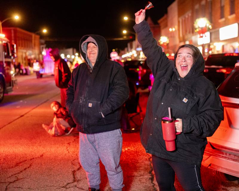 Melissa McCormick rings her bell and cheers as the Fire Department drives by during the Christmas Parade on December 7, 2025 in Spring Valley.